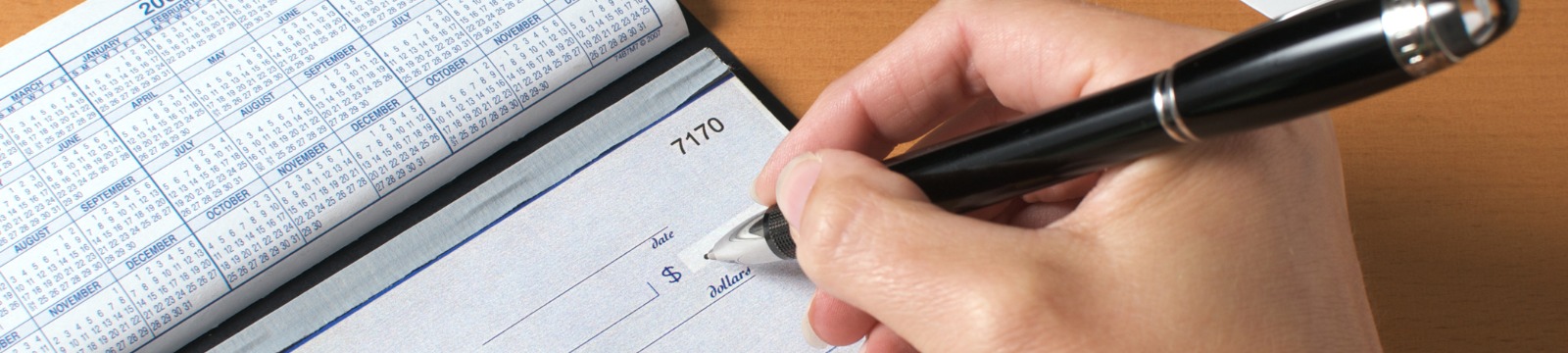 Picture of hands writing a check